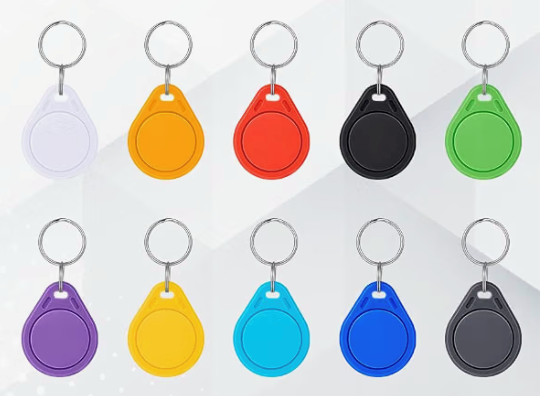 Ten pet collar tags in white, mustard, red, black, green, purple, yellow, light blue, royal blue and gray.